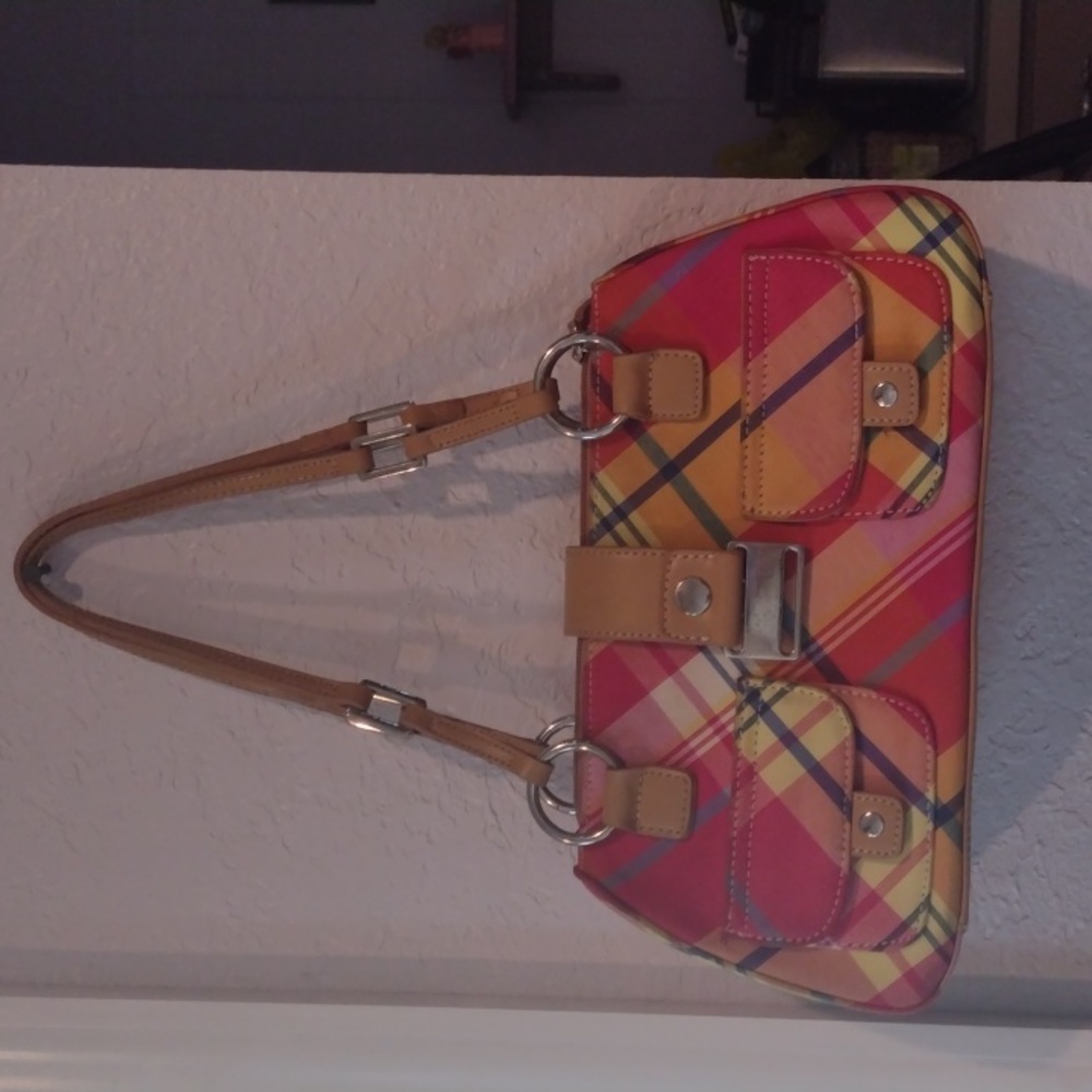 This is an adorable small tan/multicolored purse.